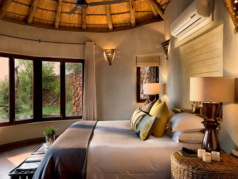 Bed in a suite at Madikwe Safari Lodge - Kopano