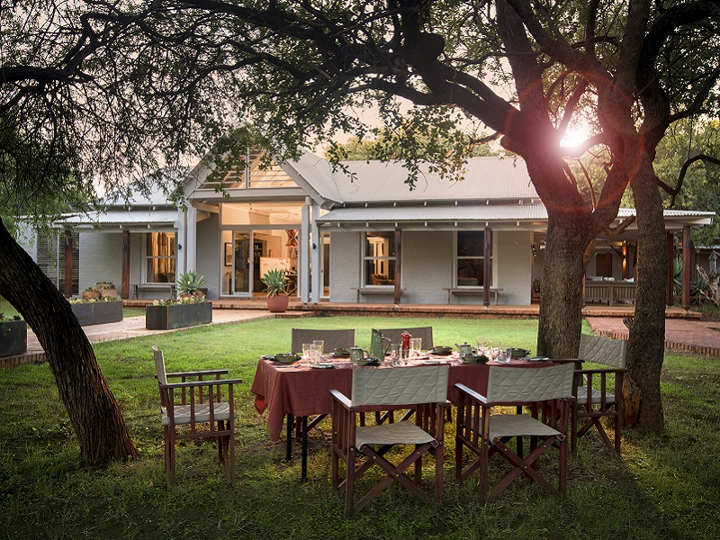 Dining in the garden at Morukuru Farm House
